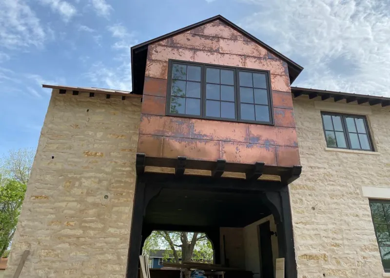 Copper metal panel facade on a stone building for Skylight Installation in Lomita